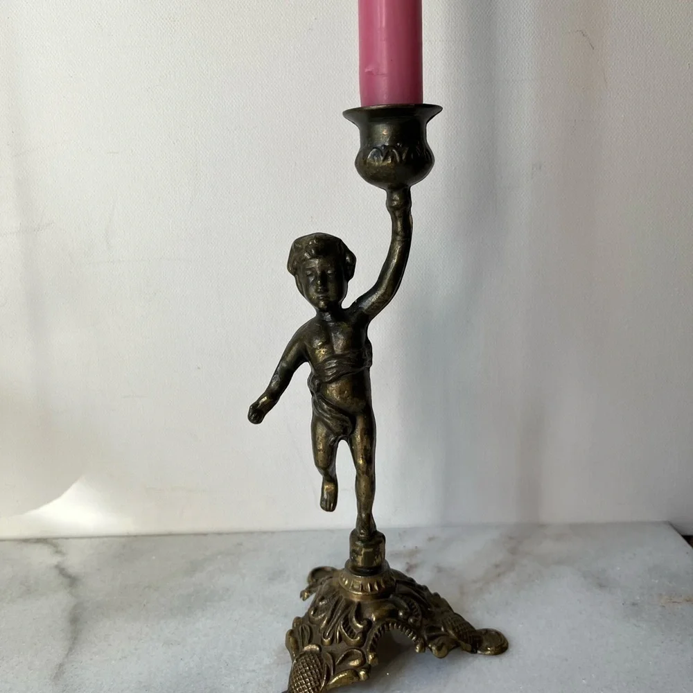 Antique cherub figurine candle holder